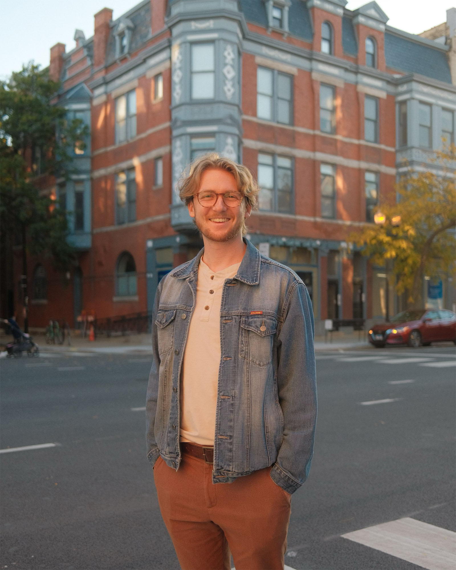 Ike Butler standing in front of a quaint street view